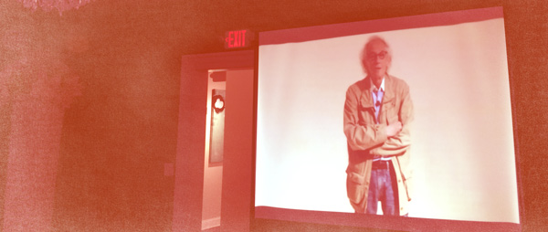 Photograph of the artist Christo presenting at MOCA  simulcast at Sweet Pete's